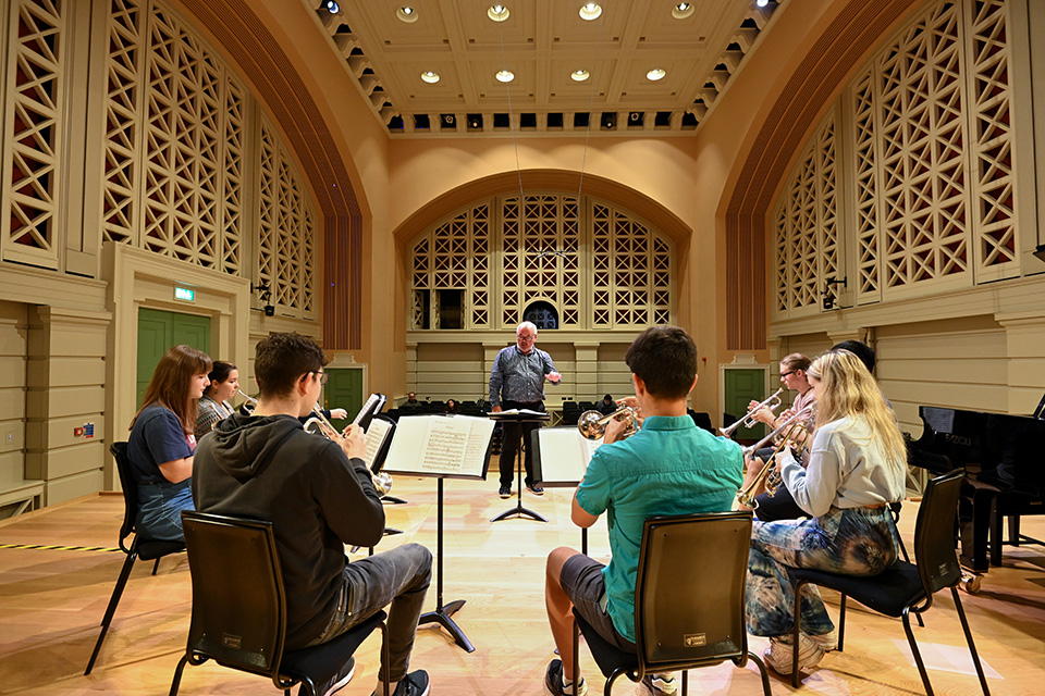 A brass class takes place on the stage of the new Performance Hall.